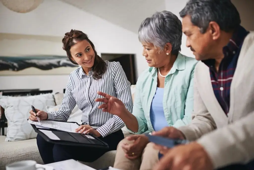 Final Expense Life Insurance agent sitting down with senior couple going over options.