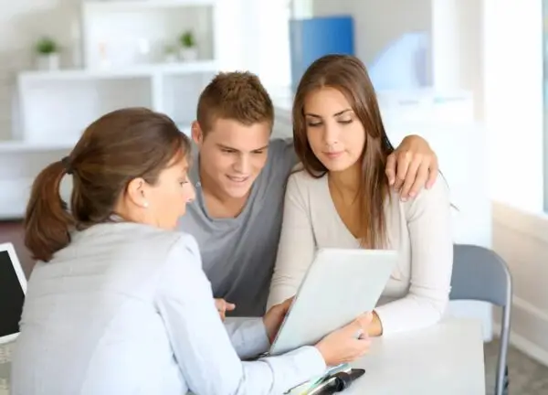 Whole life insurance agent in dodge city, kansas explaining coverage to a couple.